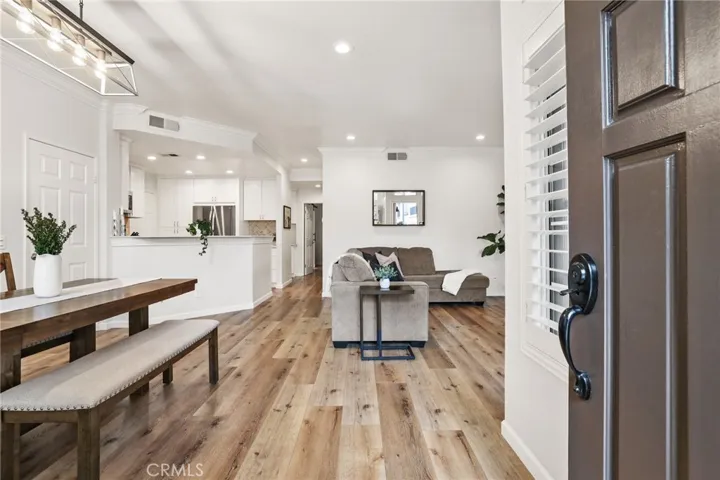 The entry opens to the dining room on the left, kitchen and living room.