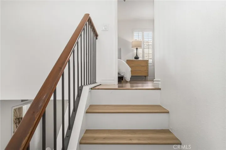 A view into the main bedroom at the top of the stairs