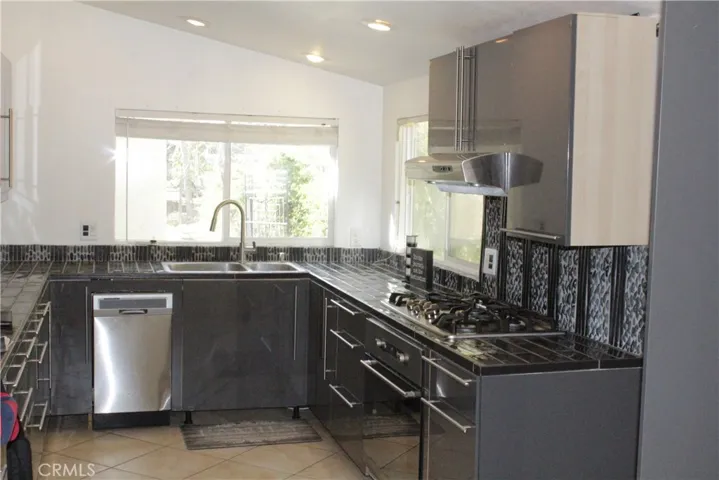 Tile floor, tile counters and recess lights in kitchen