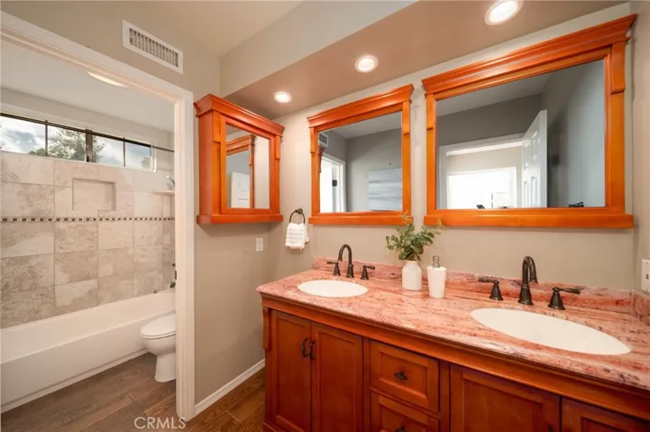 Shared bathroom upstairs with 2 sinks.