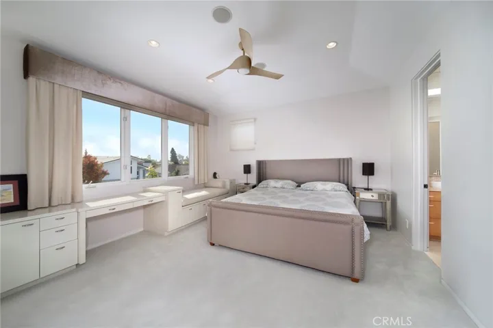 1 of 2 secondary ensuite bedrooms with balcony access.