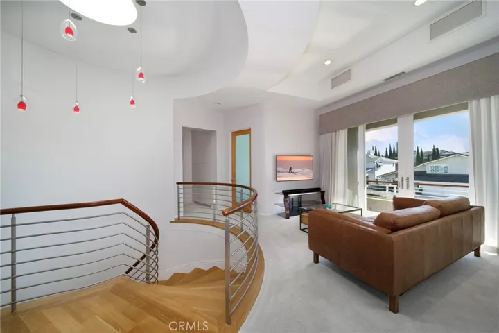 Den with an adjacent balcony.