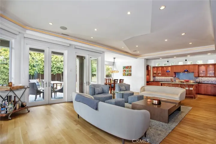 Family room opens to kitchen, breakfast nook and double French doors to backyard & pool / sp