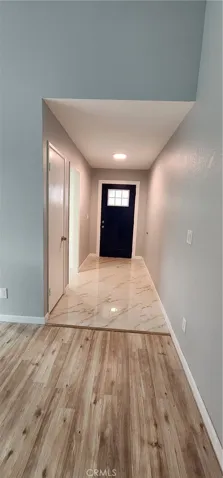 View from the living room towards the front door with marble walkway!