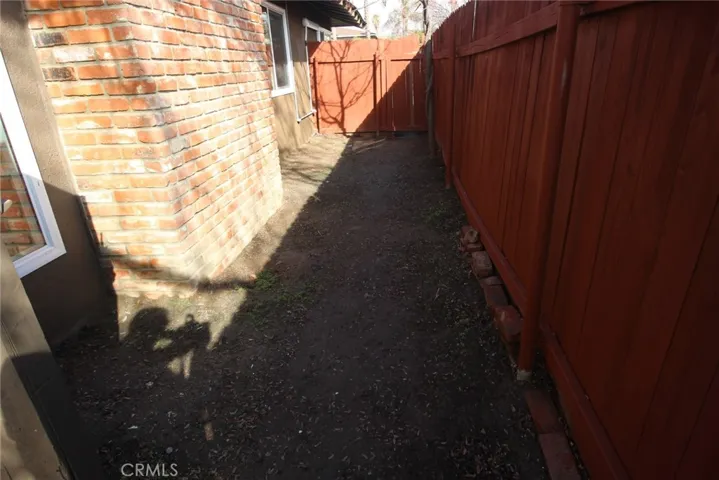 small side yard behind the fireplace bricks.......with gate to front yard