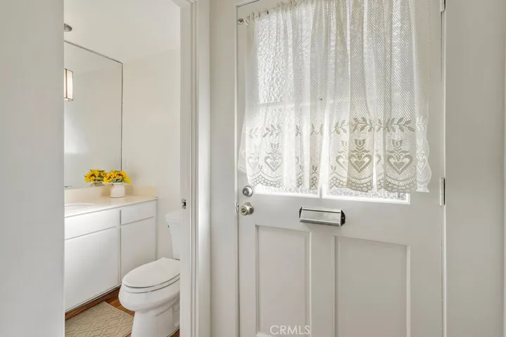 Downstairs half bathroom is located by the entrance and stairs