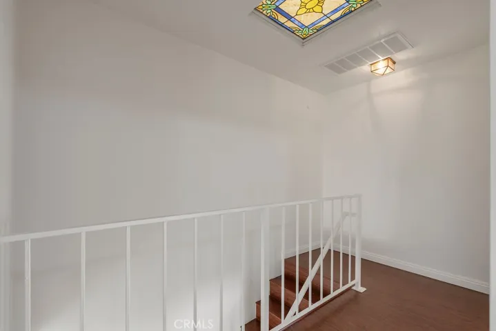 Mosaic ceiling window brings in natural light to the staircase