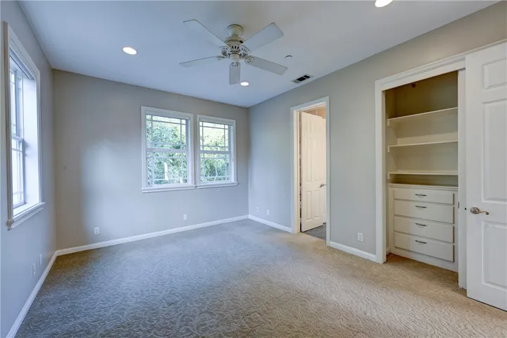 Upstairs bedroom with custom built closets, ceiling fan and recessed lights connected to the Jack n Jill bathroom.