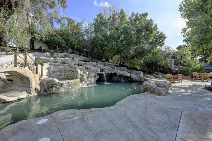 A water slide, spa, waterfalls and a grotto with lots of seating for guests in this sprawling pool.
