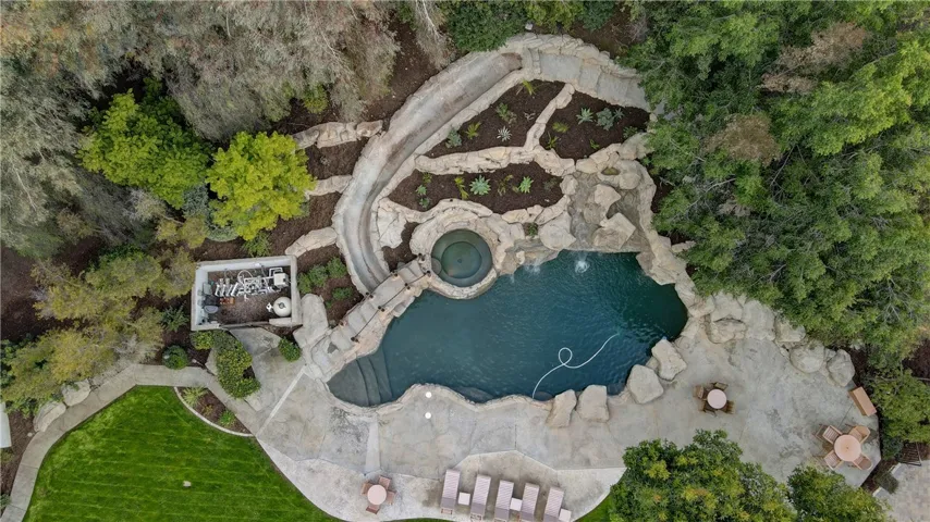 Stunning custom built pool with spa, extra long slide and a grotto!