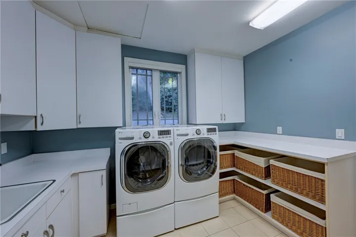 Plenty of space to sort & fold laundry in this light and bright laundry room with a window.