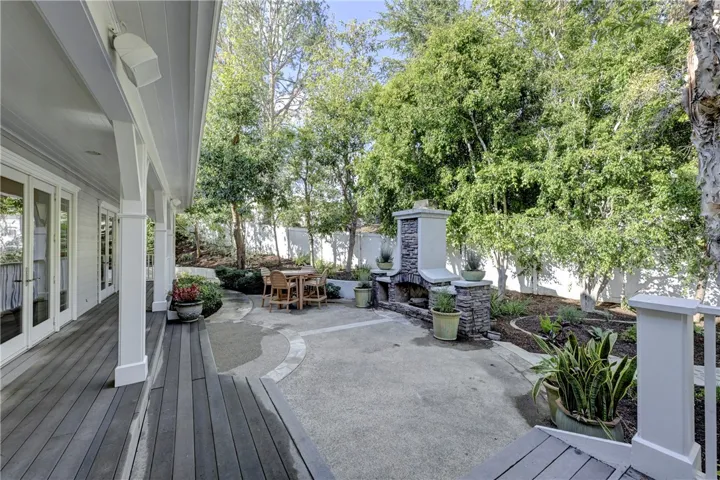 From the BBQ area step down to the stone fireplace which is right outside the formal dining room.