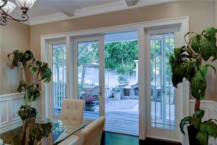 The formal dining room opens to the backyard deck and stone fireplace.