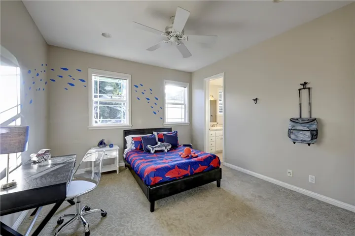 Upstairs bedroom with ceiling fan, and not seen in this photo, mirrored wardrobe doors.