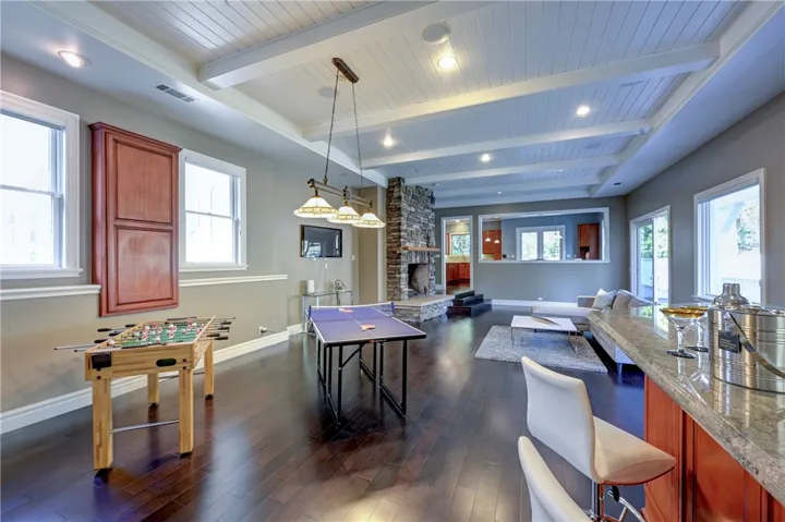 This family room has space for everyone, play games, have a drink, enjoy the fireplace or watch TV.
