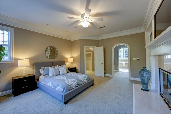 Upstairs primary ensuite bedroom with beautiful arched doorway.
