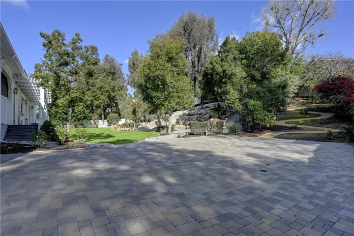  Note the extra parking next to the backyard grass and pool areas lined with pavers.