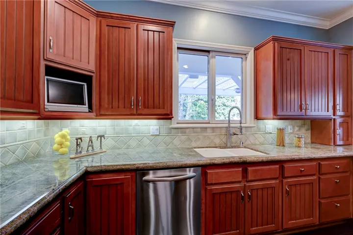 Under cabinet lighting and stainless steel appliances enhance this kitchen.