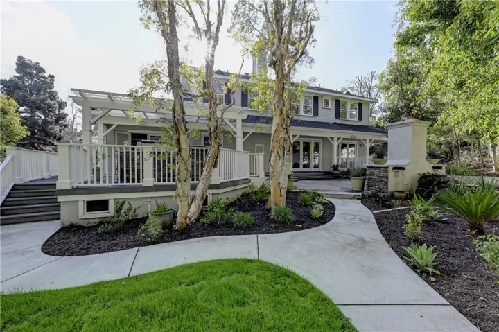 A view of the back of the property where the BBQ and outdoor stone fireplace are located.