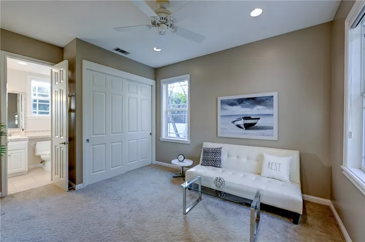 Upstairs bedroom/teen hangout with ceiling fan and recessed lighting.