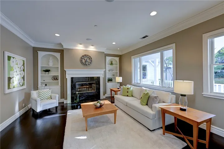Quiet formal living room with fireplace and beautiful black tile hearth.