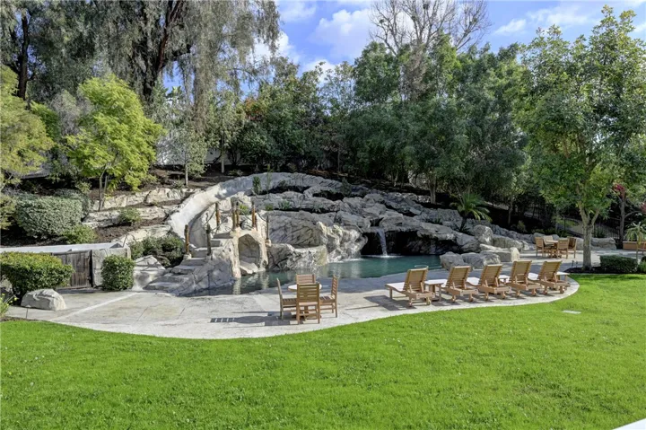 Note the steps up to the spa to the center left of the pool as well as the waterfalls.
