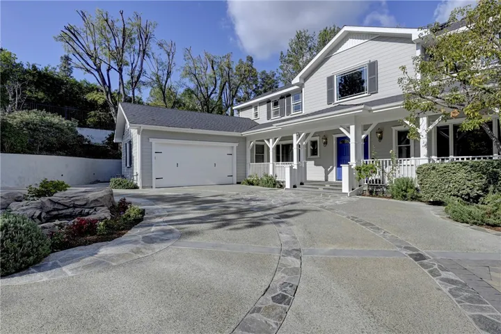 Large porch along the front of the house and wraps around the entire house. Also, note that this 2 car garage is extra large inside and also holds a work bench.