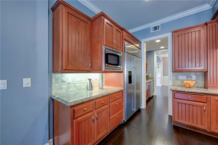 Extra large refrigerator, microwave and a perfect area for a coffee bar in this spacious kitchen. You can see the butler's panty in this photo and the walk in pantry is across from the butler's pantry.