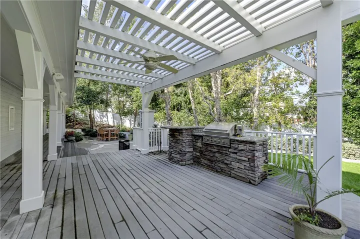Wraparound deck with stone BBQ and note the ceiling fan for the warmer months.