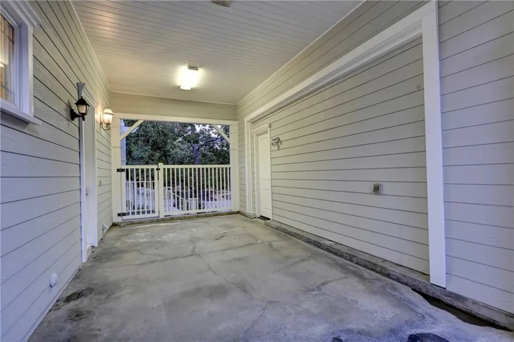 Carport with has EV charging station and  access to the house. Door to the left is direct access to the house.