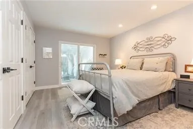 Main floor bedroom with access to back patio through French sliders with built-in blinds