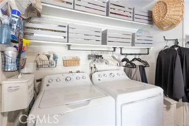 Inside garage with washer and dryer plus storage