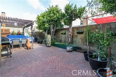 Brick paved patio with trees and garden