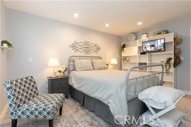Primary bedroom with recessed lighting and plenty of extra space for furniture