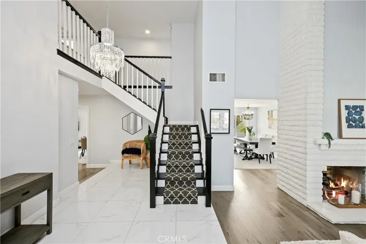 Beautiful soaring ceilings and remodeled staircase make a grand entry.