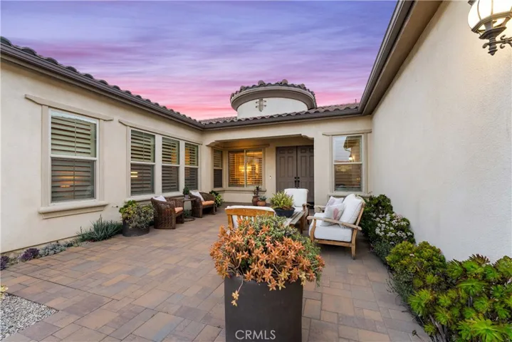 Amazing paved courtyard to the double door entry.
