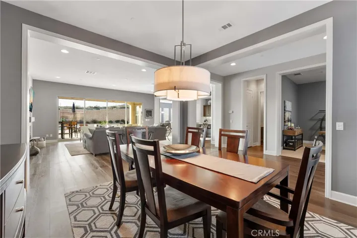 Dining room with view of the living and large foyer with office in the distance.