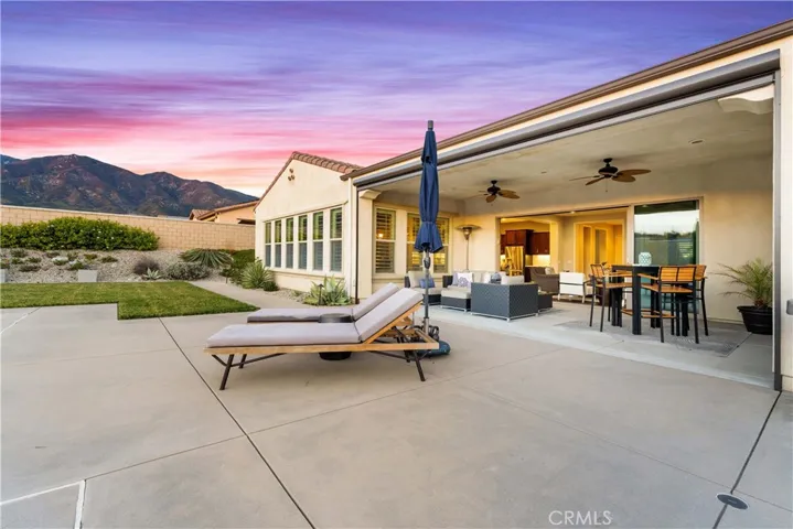 Spacious covered patio with remote screen. (screen is up in this image) California Sliding Doors.
