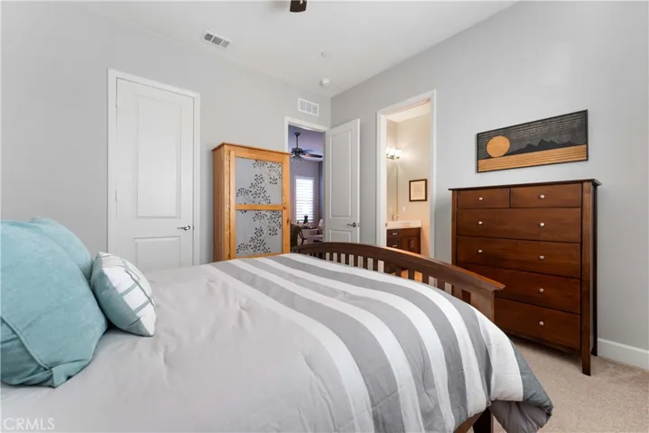 One of four bedrooms with ceiling fan.