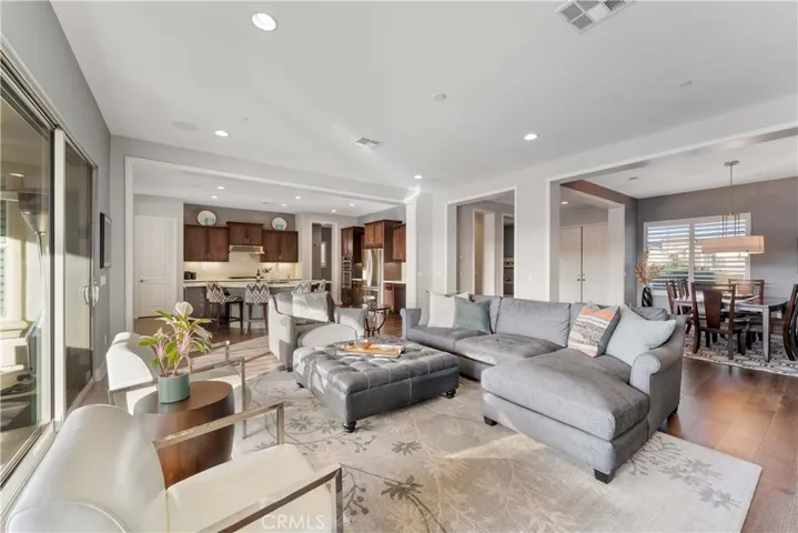 Open space living shows dining in the distance and kitchen.