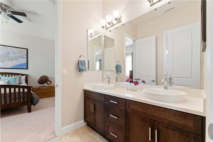 Double sinks in bath between two bedrooms.