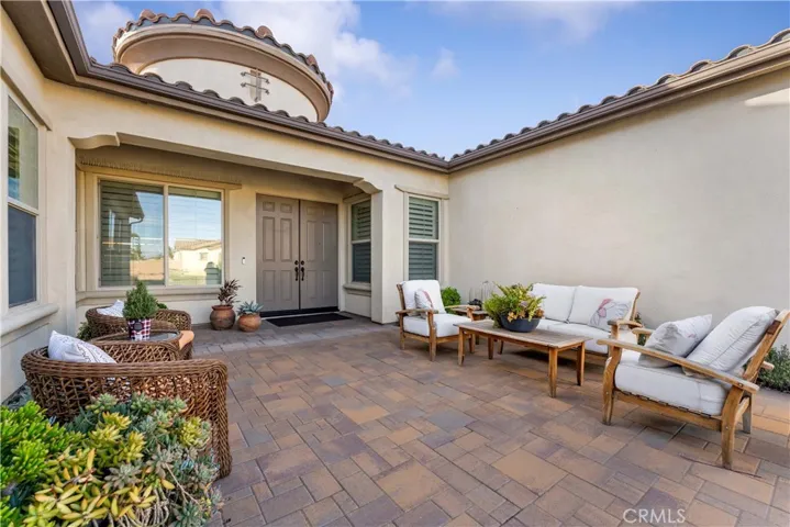 Beautiful courtyard to double door entry with pavers.