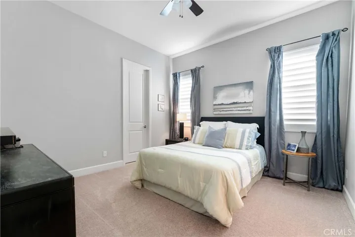 One of four bedrooms with ceiling fan.