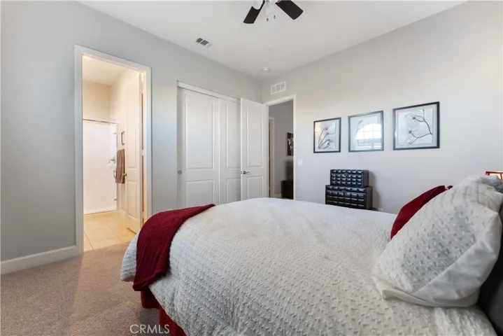Second primary bedroom with ceiling fan.
