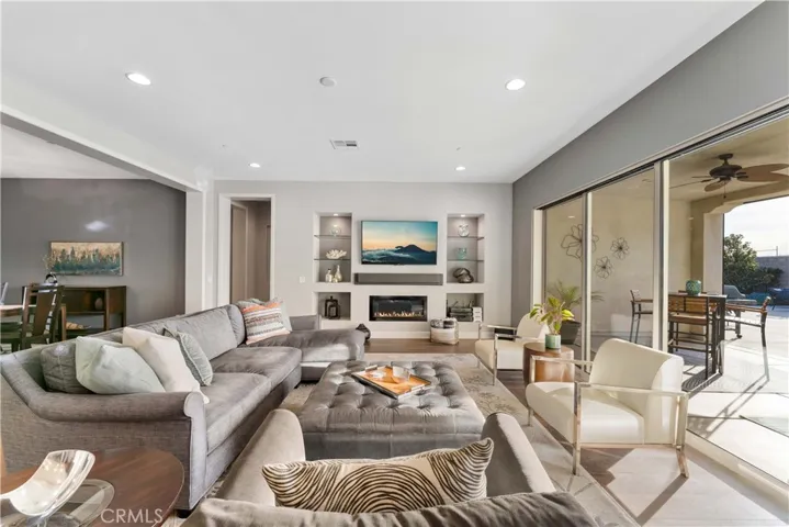 Beautiful living room with gas fireplace, wood floors, recessed lights, 10' foot high ceilings.