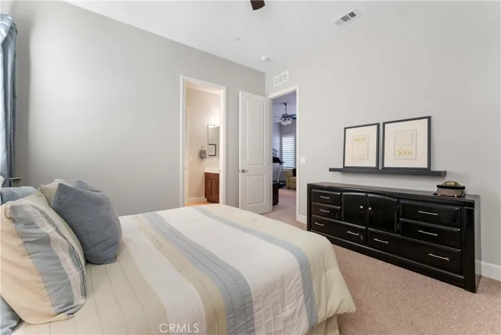 One of four bedrooms with ceiling fan.