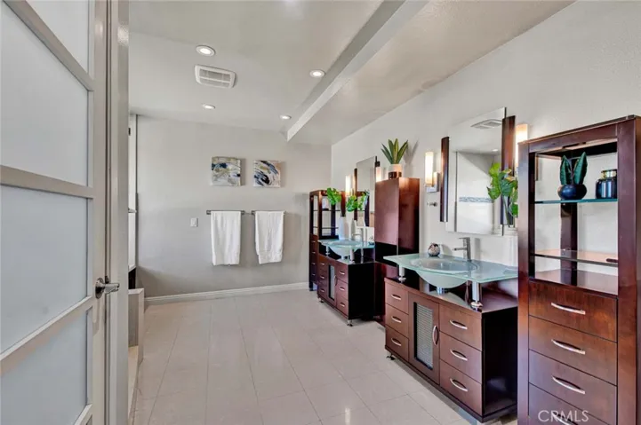 Upgraded Primary Suite Bathroom with Dual Vanities and Chic Fixtures