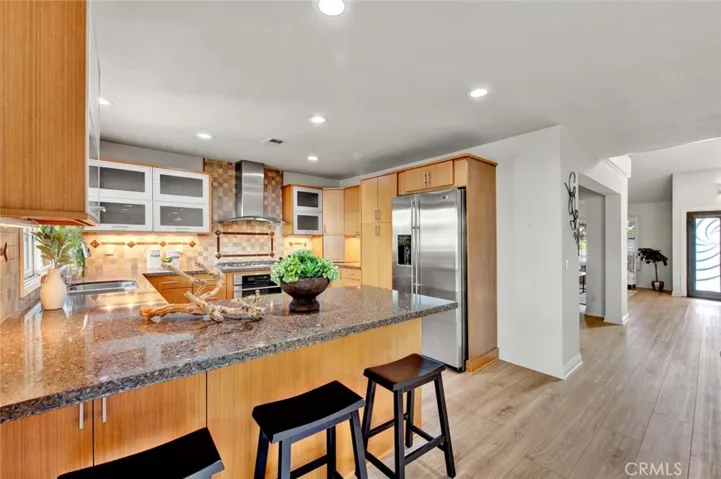 Caesarstone Quartz Countertops, Breakfast Bar, Stainless GE Monogram Appliances (5-Burner Gas Cooktop, Electric Oven, Microwave, Dishwasher), and Custom Soft-Closing Cabinetry with Pull-Outs, Hidden Recycle Trash, Lazy Susan, and Other Specialty Spaces