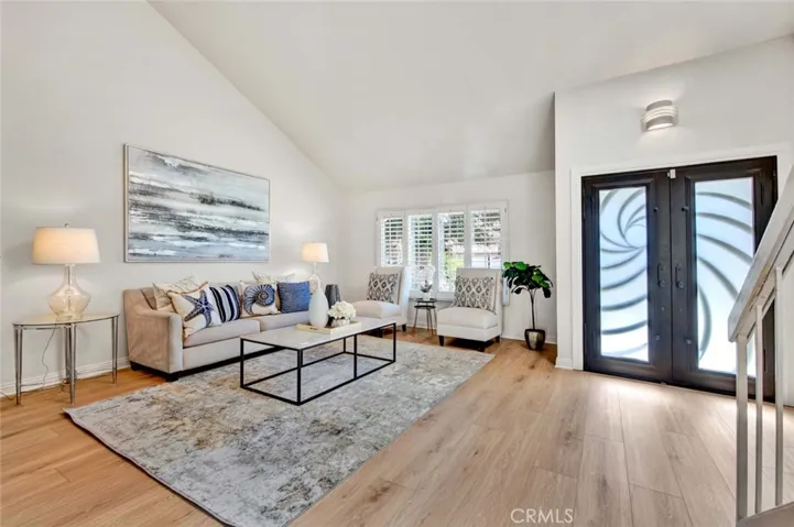 Custom Wrought Iron and Frosted Glass Double Entry Doors Open to Formal Living Room with Vaulted Ceiling