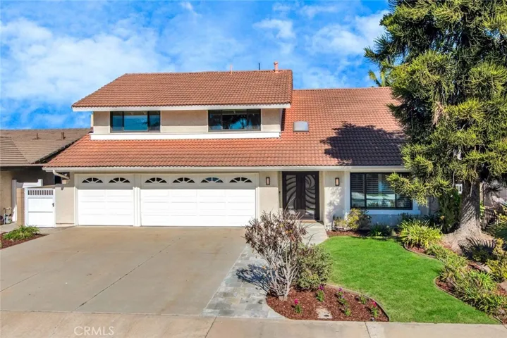 Lovely Curb Appeal with Spanish Tile Roof and Flagstone Walkway Leading to the Custom Wrought Iron and Glass Double Door Entry